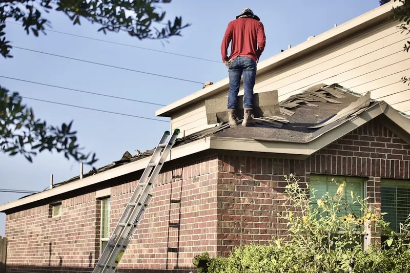 Professional roofer working on a residential roof in Liberty Triangle